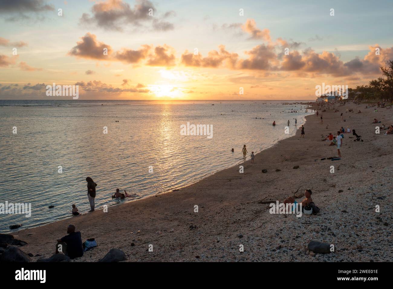 The beach at Saint-Pierre lagoon, Réunion Island, at sunset. Tourists, family and people enjoying the scenic view. It is a popular travel destination Stock Photo