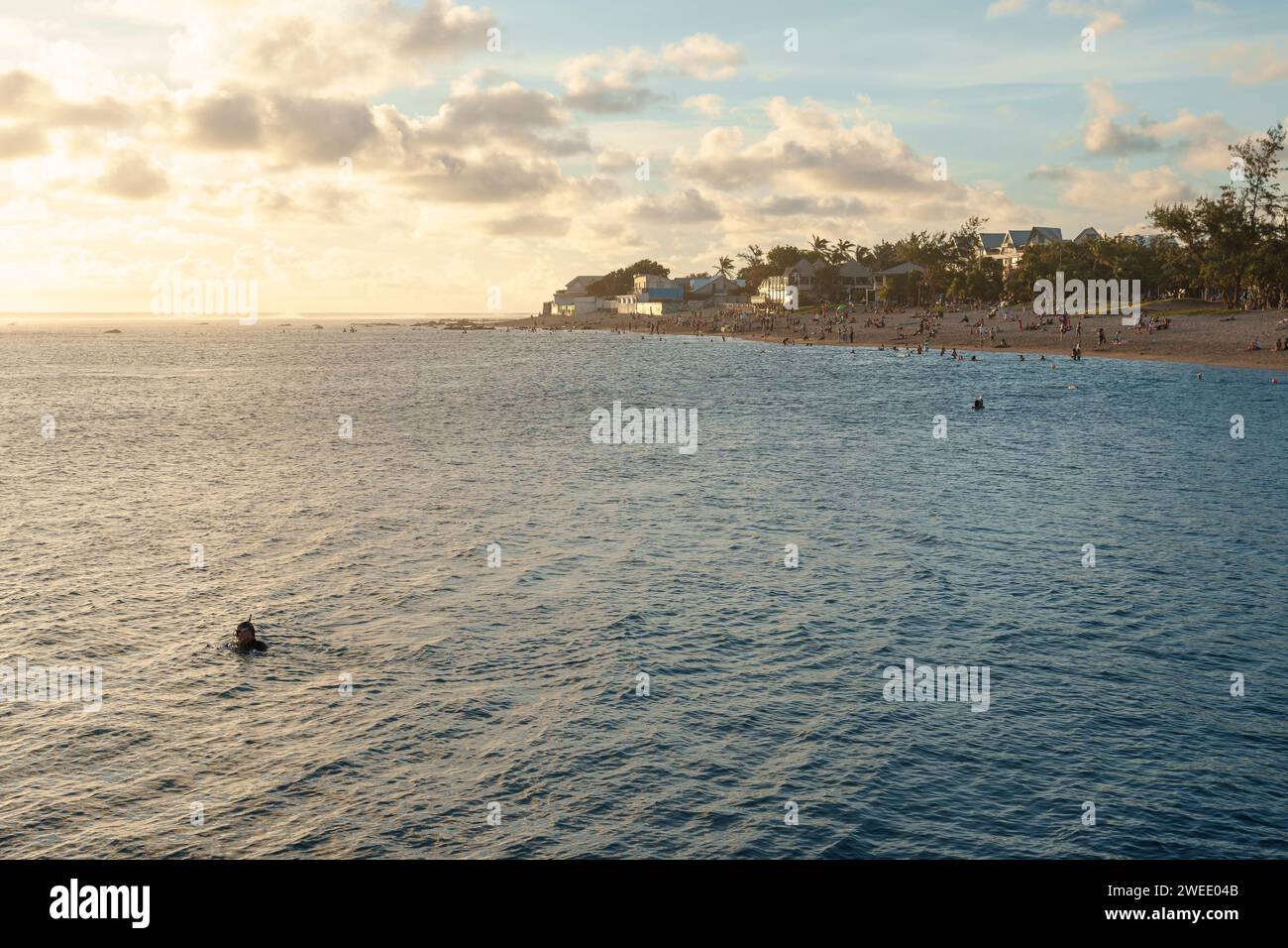 People snorkelling and swimming in the lagoon of Saint-Pierre, Reunion Island, at sunset. Stock Photo