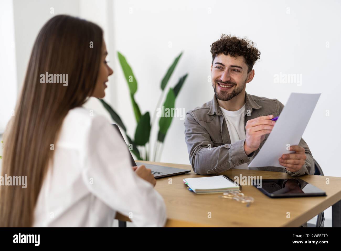 Real estate agent with woman closing a deal and signing a contract Stock Photo