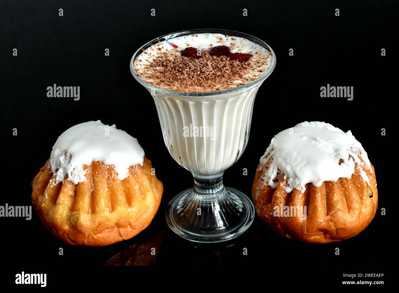 Two butter cakes with vanilla, raisins, soaked in rum called baba and a ...