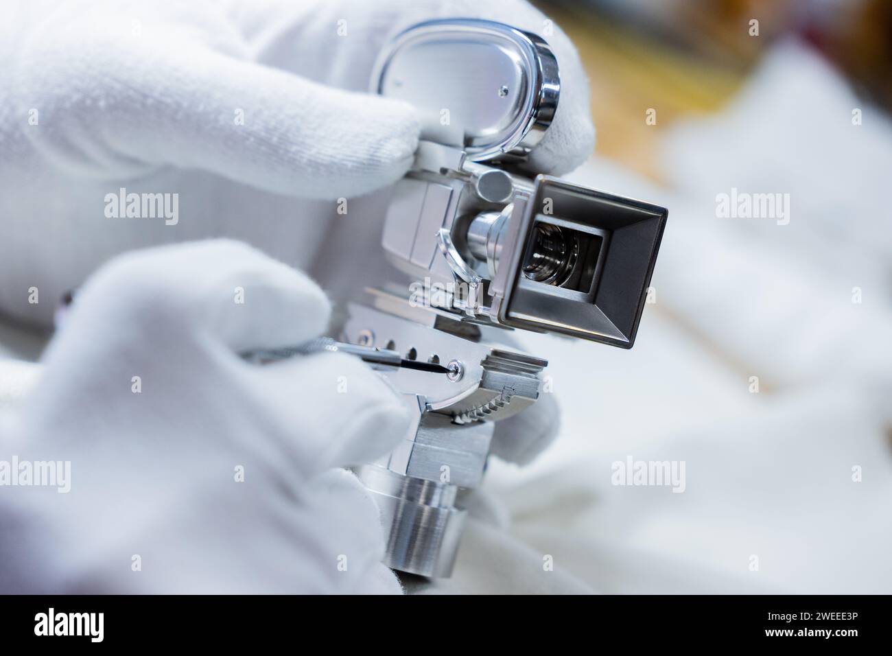Duesseldorf, Germany. 18th Jan, 2024. An employee checks the screws of a Berlinale camera at the Hornemann goldsmiths. For over 30 years, the silver Berlinale cameras have been made here for the Berlinale, honoring personalities who have rendered outstanding services to filmmaking. Credit: Rolf Vennenbernd/dpa/Alamy Live News Stock Photo