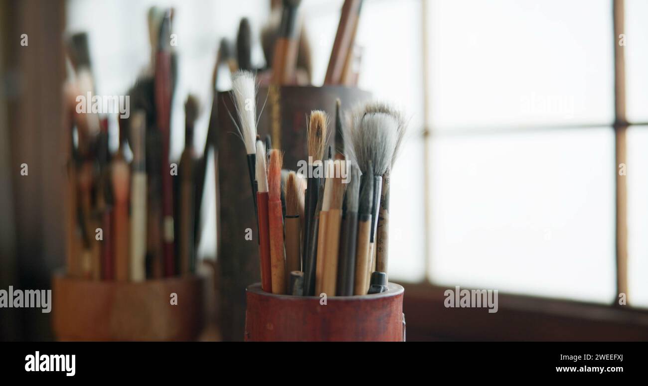 Paint brush, equipment and supplies in empty workshop closeup for art, creative or talent showcase. Studio interior or room with still life objects Stock Photo