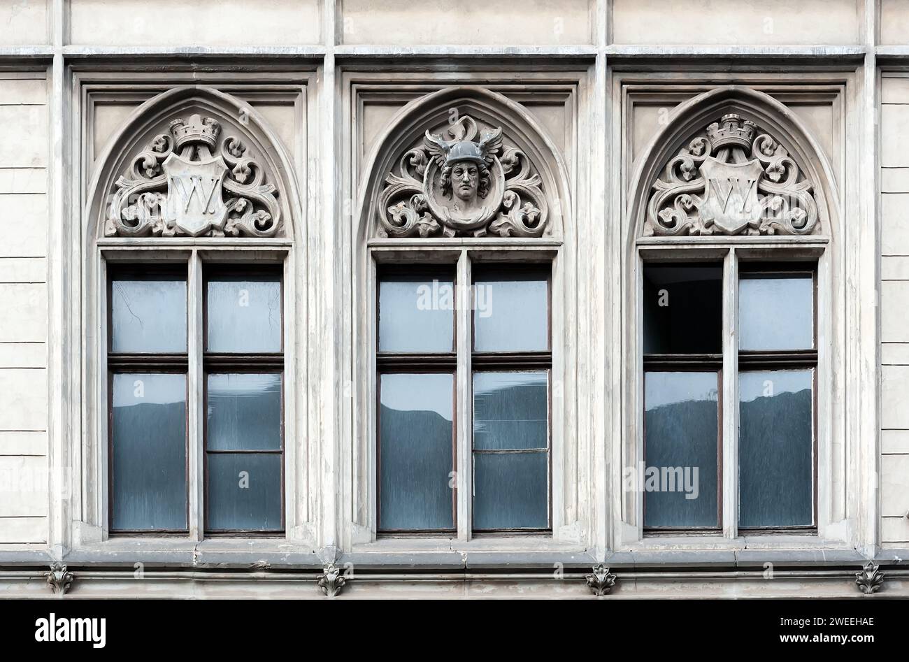 Old building facade with three windows with decorations Stock Photo - Alamy