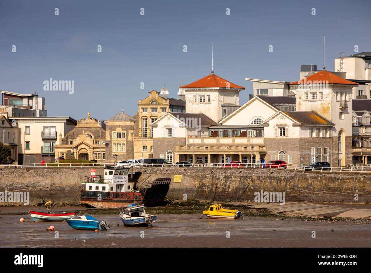 UK, England, Somerset, Weston-super-Mare, Knightstone Island, boats moored near former Spa buildings at low tide Stock Photo