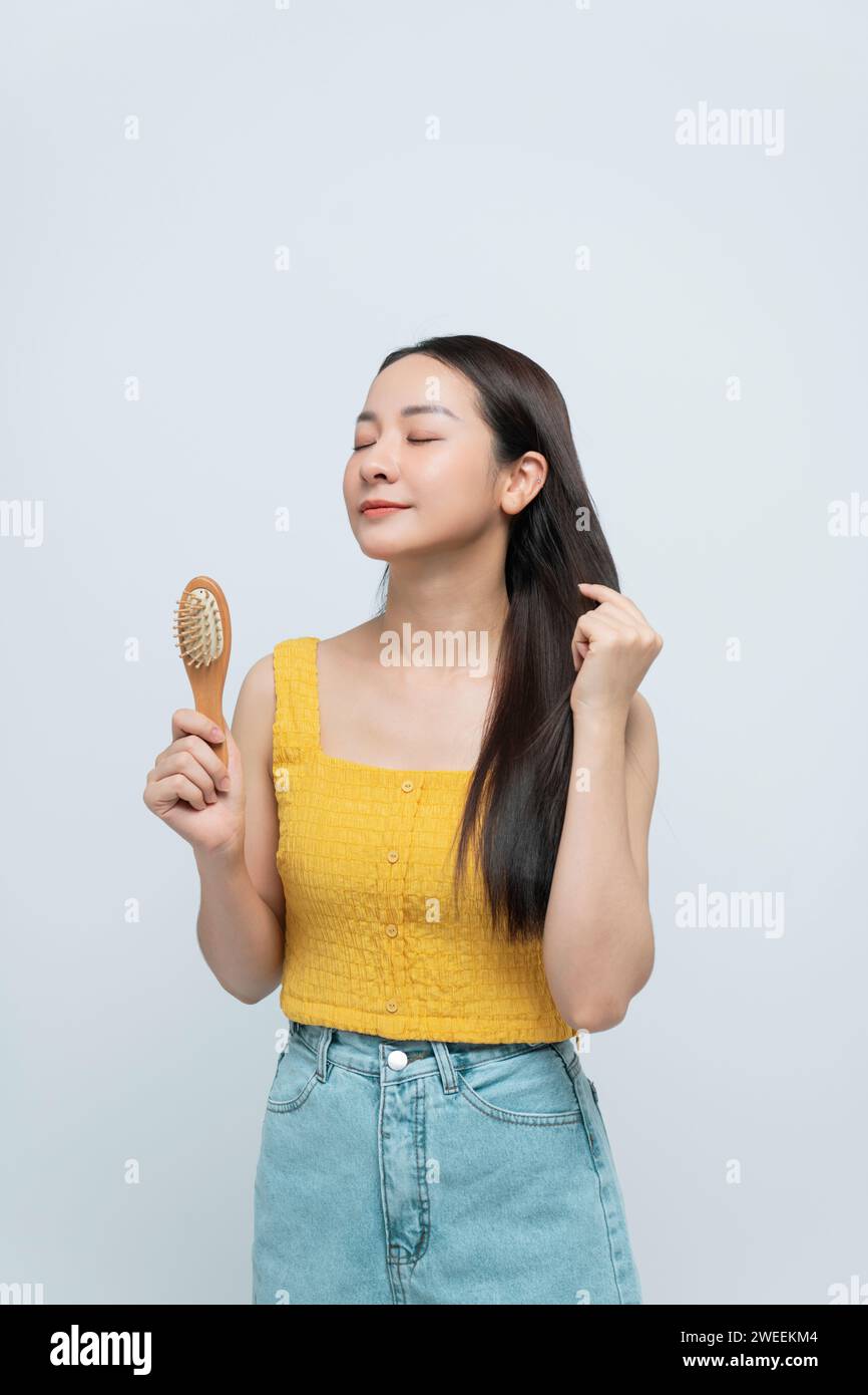 Woman is making hairstyle with comb. Stock Photo