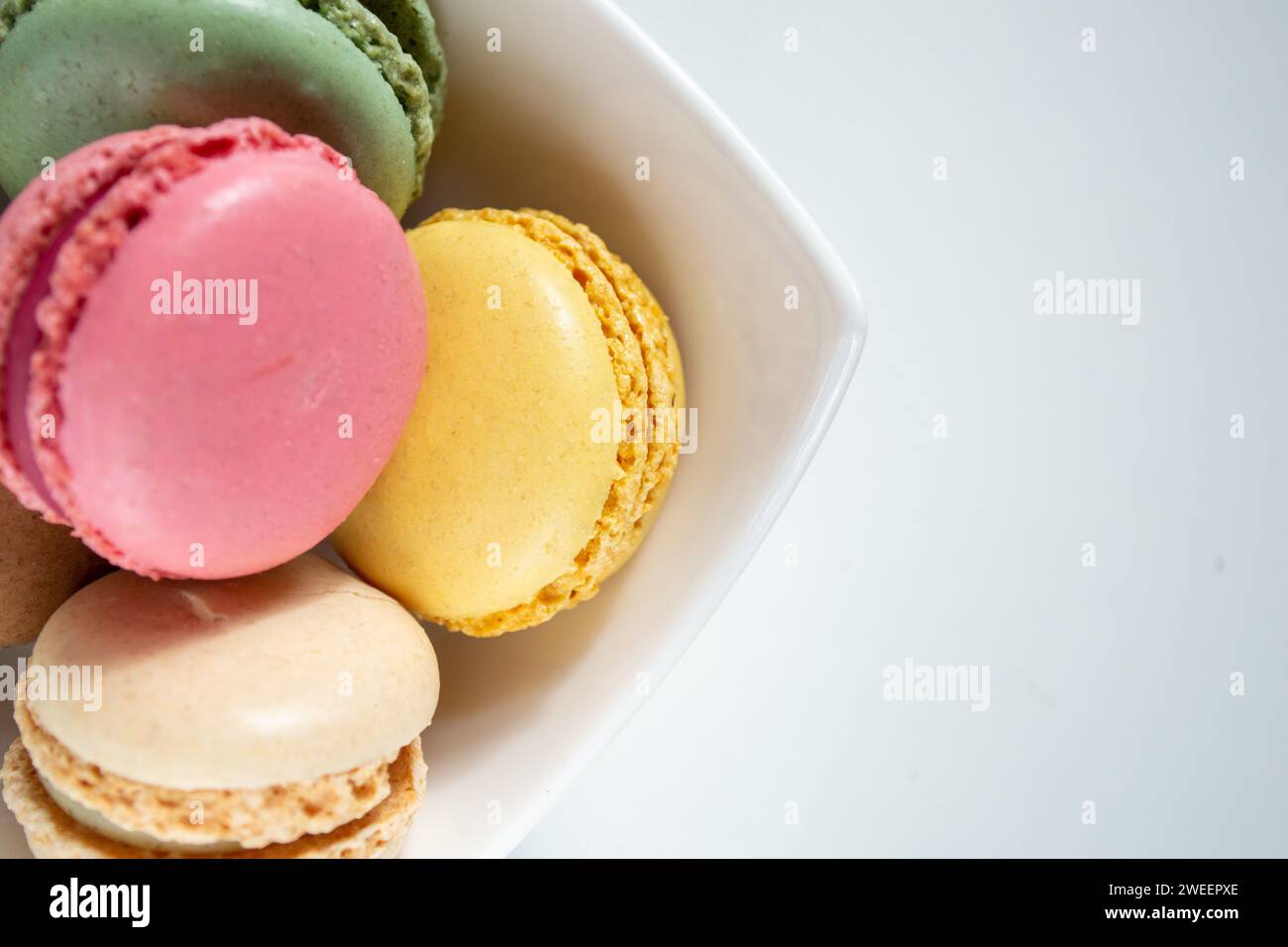 small macaroons in a white plate on a white background Stock Photo
