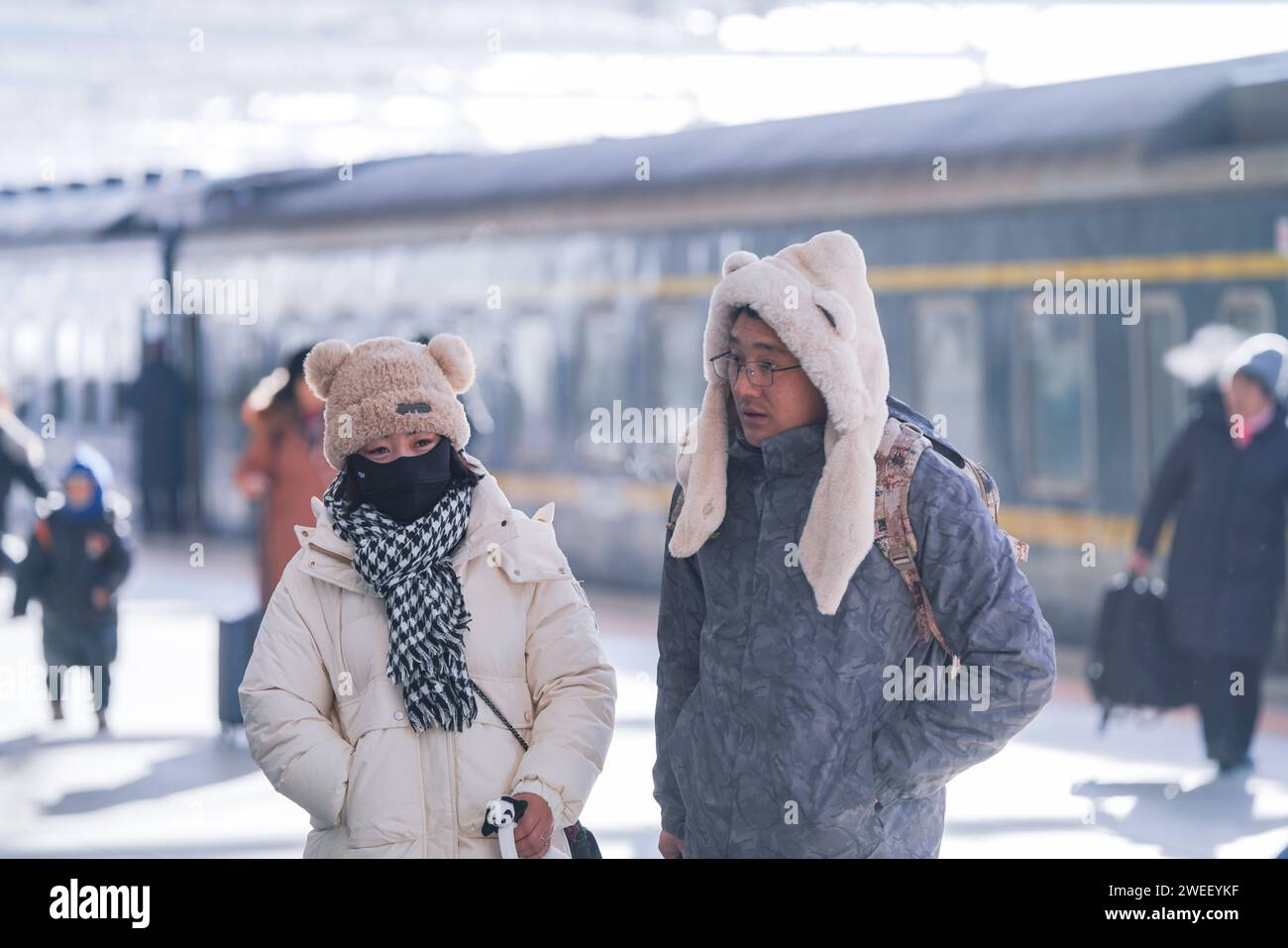 (240125) -- HARBIN, Jan. 25, 2024 (Xinhua) -- Passengers get off the train K7065 from Harbin to Fuyuan after arriving in Fuyuan, northeast China's Heilongjiang Province, Jan. 23, 2024. The train K7065/K7066 travels to and fro between the city of Harbin and Fuyuan in China's northeastern province of Heilongjiang. With a single journey time of nearly 15 hours, the train replaced old carriages with new ones having air conditioning system, offering a better travel experience for locals who visit friends or commute to work or study along the line. (Xinhua/Wang Song) Stock Photo