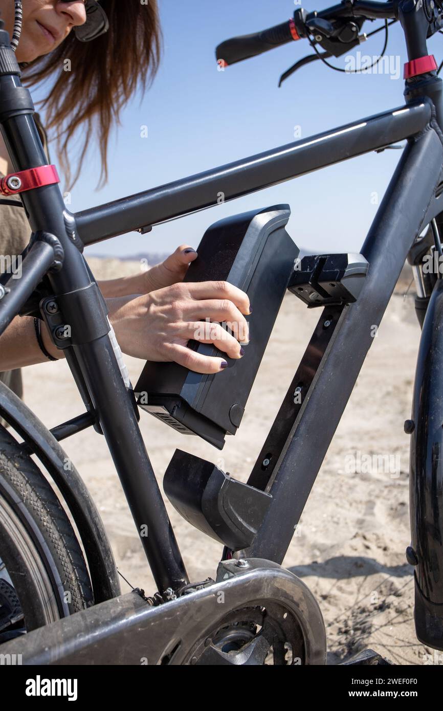 removing electric bike battery from frame Stock Photo Alamy