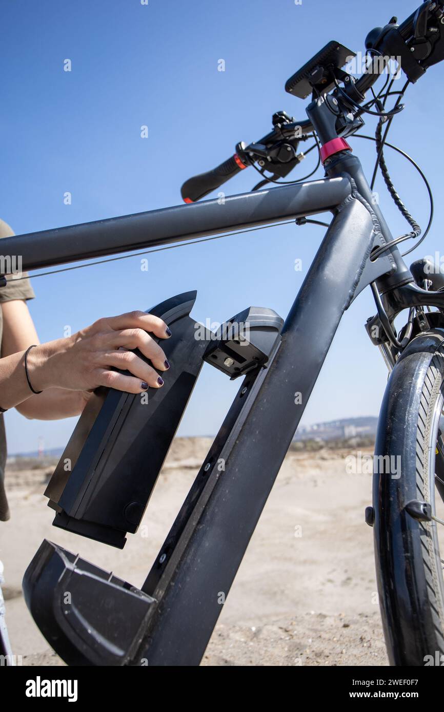 removing electric bike battery from frame Stock Photo Alamy
