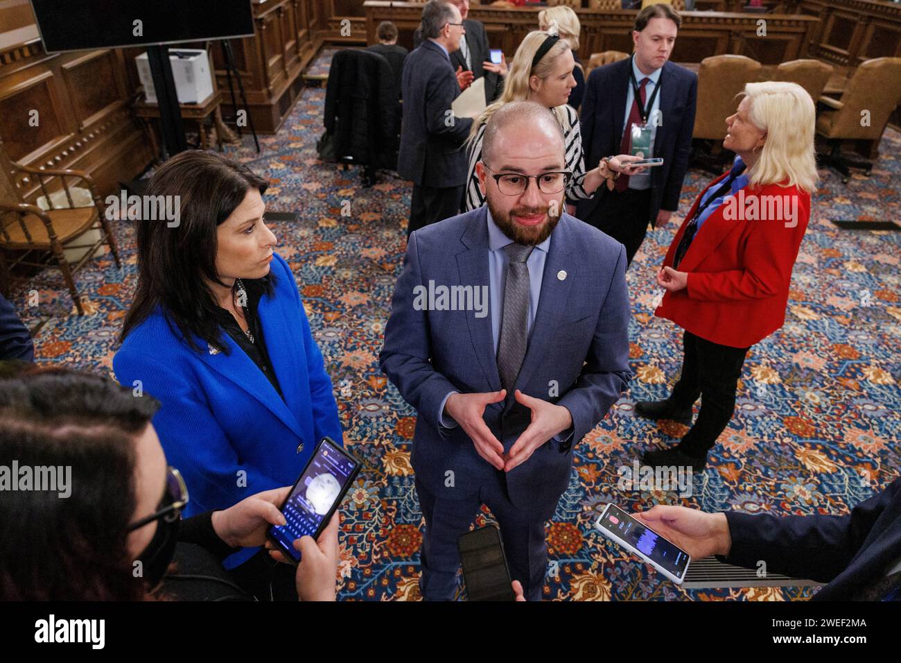 Attorney General Dana Nessel, left, and state Sen. Jeremy Moss (D-Southfield), center, speak to reporters in Lansing following Gov. Gretchen Whitmer's State of the State address on Jan. 24, 2024. State Sen. Ruth Johnson (R-Holly), right, speaks to another group of reporters. (Photo by Andrew Roth) Stock Photo