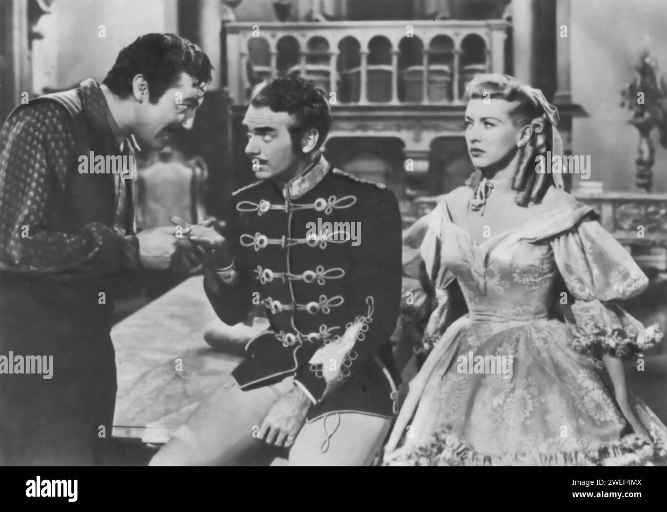 Cesar Romero, Douglas Fairbanks Jr., and Betty Grable star in 'That Lady in Ermine' (1948), a musical comedy. In this film, Grable plays Francesca, the countess of an Italian town during World War II, who is visited by the invading Hungarian army led by Fairbanks' character. Romero adds to the comedic elements of the plot. Stock Photo