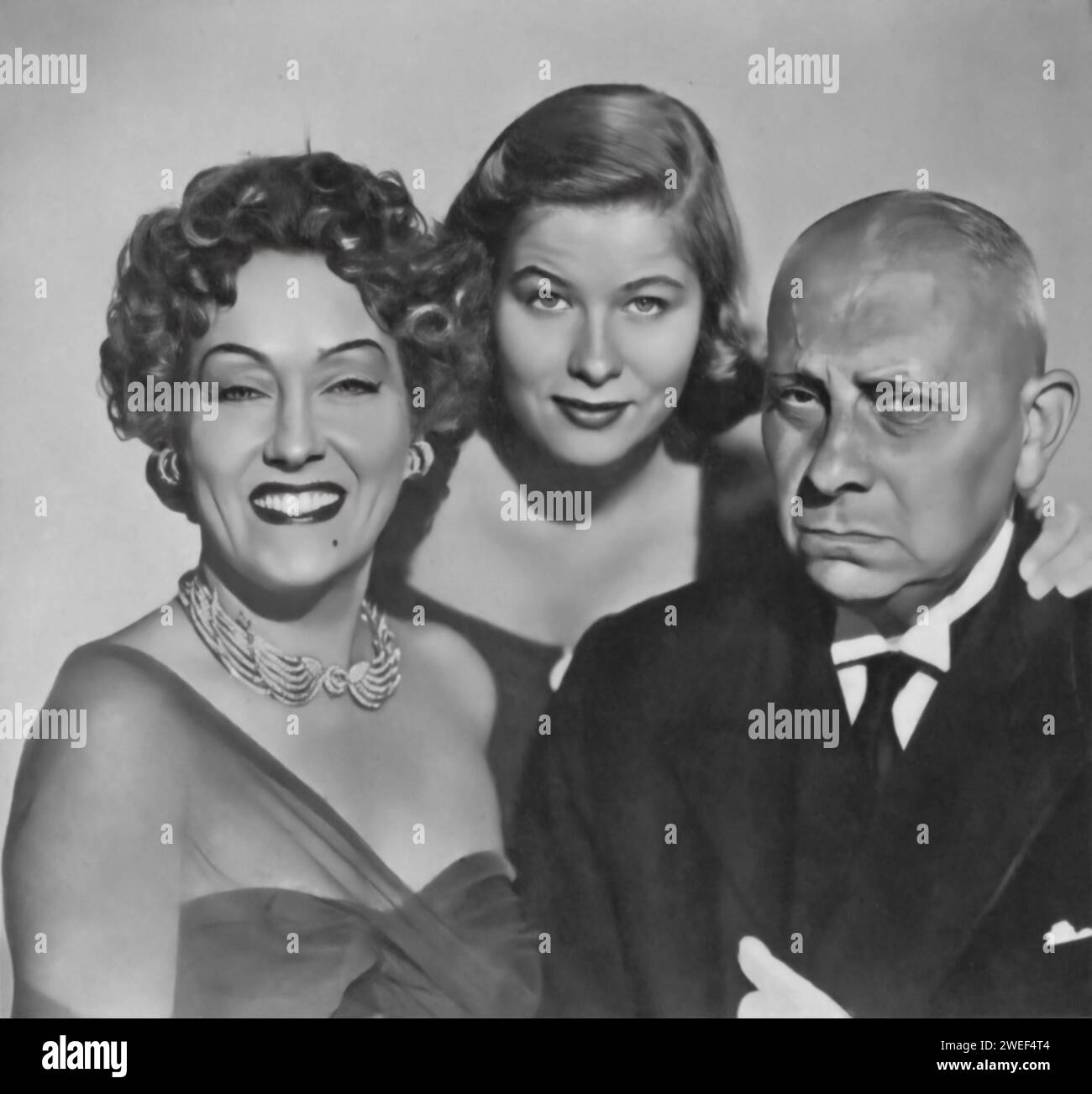 Gloria Swanson, Erich von Stroheim, and Nancy Olson star in 'Sunset Boulevard' (1950), a classic film noir directed by Billy Wilder. Swanson delivers a legendary performance as Norma Desmond, a faded silent film star living in delusion, while von Stroheim portrays Max von Mayerling, her devoted butler and former husband. Olson plays Betty Schaefer, an aspiring screenwriter who becomes involved with Joe Gillis, played by William Holden. Stock Photo