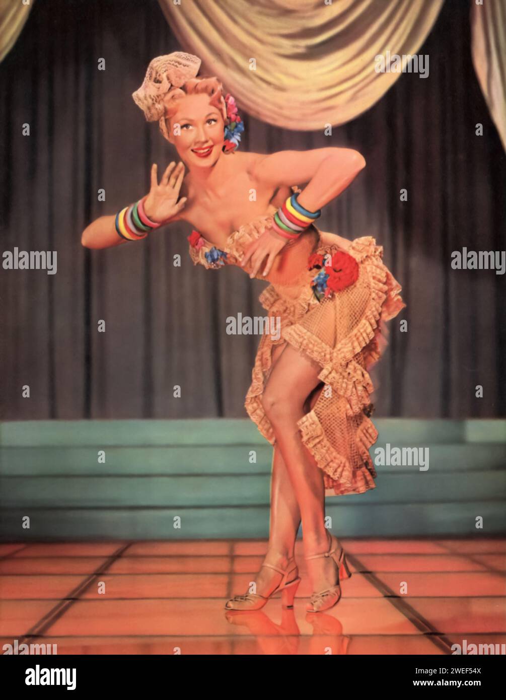 Virginia Mayo stars in 'Painting the Clouds with Sunshine' (1951), a musical film filled with vibrant performances and catchy tunes. In this movie, Mayo plays Carol, a member of a singing trio trying to strike it rich in Las Vegas. Stock Photo