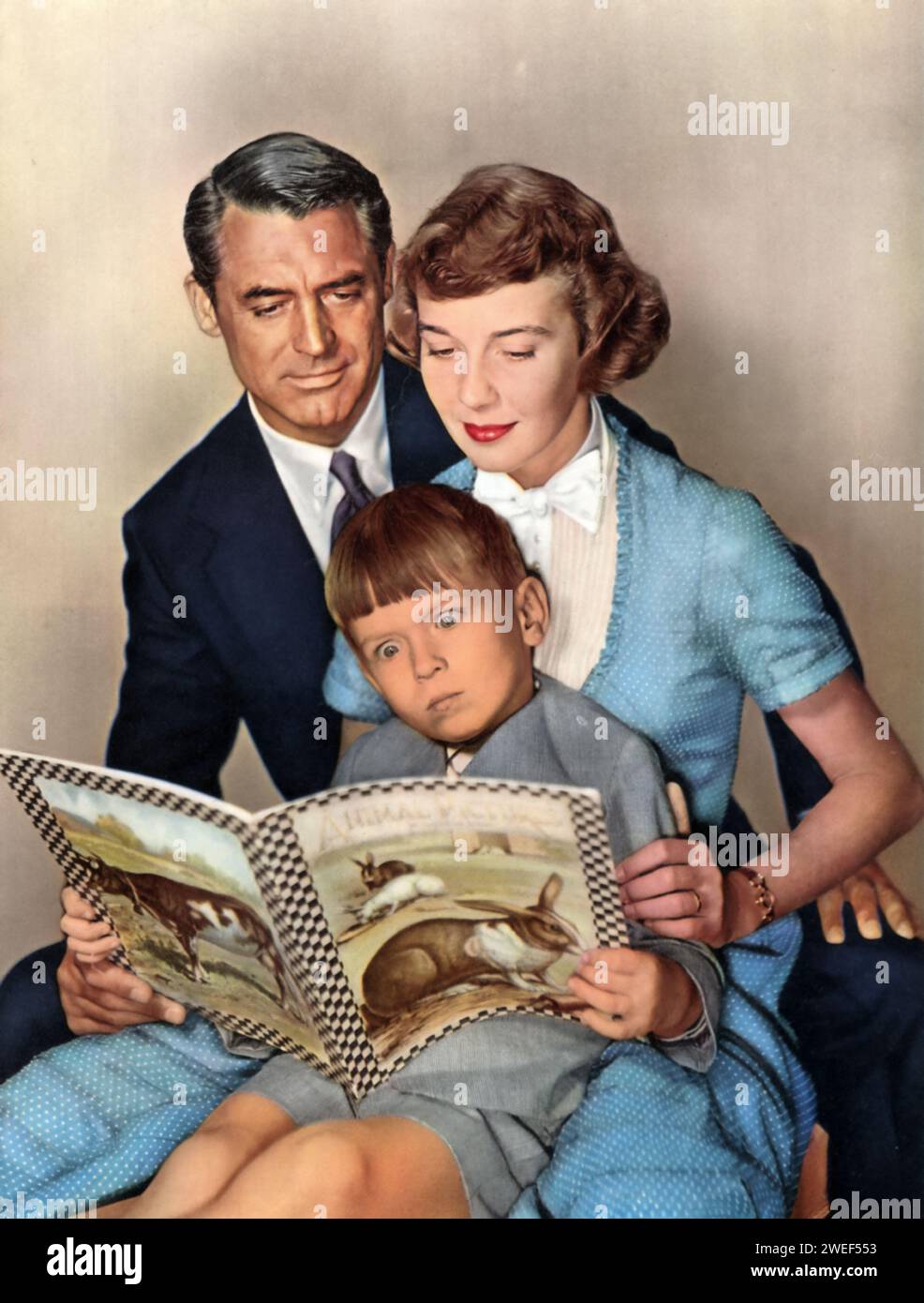 A portrait of Cary Grant, Betsy Drake, and George Winslow, starring in 'Room for One More' (1952). In this heartwarming family comedy, Grant and Drake, a real-life couple at the time, play George and Anna Rose, a pair who open their home and hearts to a series of foster children, including a character played by young George Winslow. The film showcases the challenges and joys of a growing family, with Grant and Drake's natural chemistry enhancing the film's charm and warmth. Stock Photo
