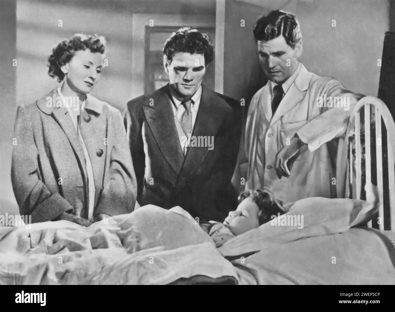 Anthony Steel, Freddie Mills, and Joy Shelton star in 'Emergency Call' (1952), a British drama film. Steel plays Dr. Graham, a dedicated physician, with Mills as Sergeant Harry Graham, and Shelton portraying Nurse Yvonne, each pivotal in the emergency services world. Stock Photo