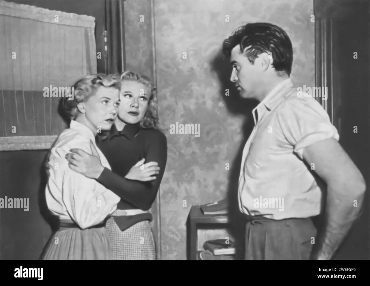 Ginger Rogers, Doris Day, and Steve Cochran star in 'Storm Warning' (1951), a film noir drama. In the movie, Rogers plays Marsha Mitchell, a model who accidentally witnesses a murder committed by the Ku Klux Klan in a small town. Day portrays her sister, Lucy Rice, who is unaware of her husband's (played by Cochran) involvement with the Klan. The film explores the themes of racism, corruption, and moral conflict as Marsha grapples with the decision to speak out against the Klan, despite the dangers and personal costs. Stock Photo