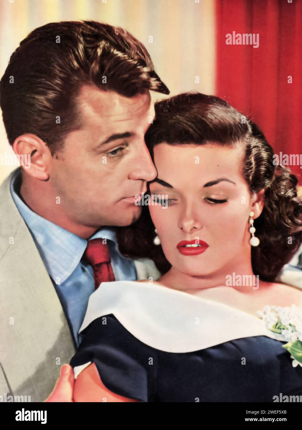 A portrait of Robert Mitchum and Jane Russell, stars of the film 'His Kind of Woman' (1951). In this film noir, Mitchum plays Dan Milner, a down-on-his-luck gambler who finds himself embroiled in a complex plot involving crime and intrigue. Russell portrays Lenore Brent, a singer and love interest of Milner. Set in a glamorous Mexican resort, the film combines suspense, romance, and dark humor. Stock Photo