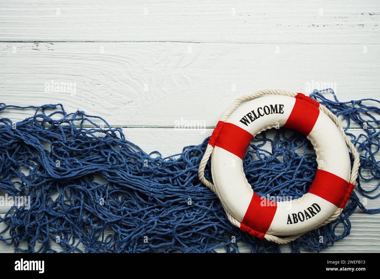 Nautical Lifebuoy and Blue Fishing net frame with space copy on wooden ...