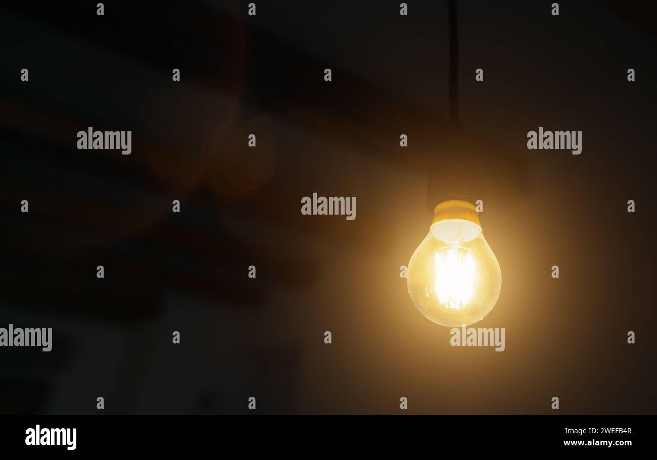 Lit Incandescent light bulb with a medium-sized E27. Stock Photo