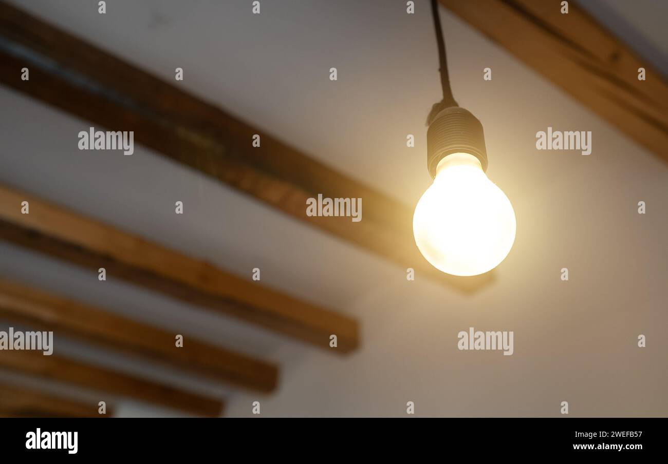 Lit Incandescent light bulb with a medium-sized E27. Stock Photo