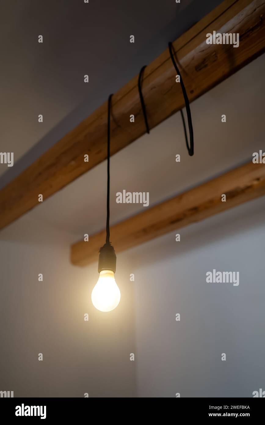 Lit Incandescent light bulb with a medium-sized E27. Stock Photo