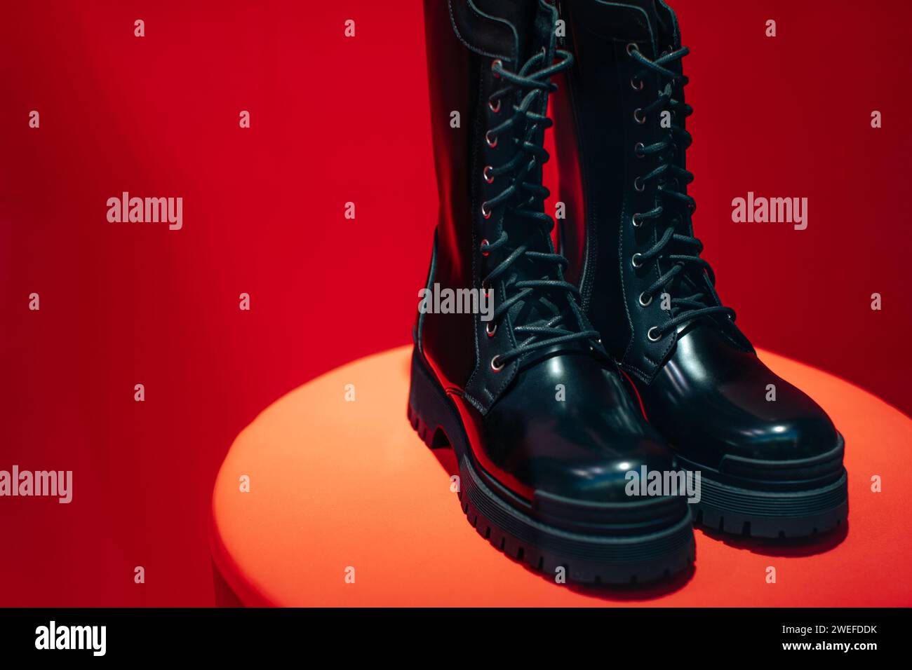 Black women's patent leather lace-up shoes on a boutique stand on a red background Stock Photo