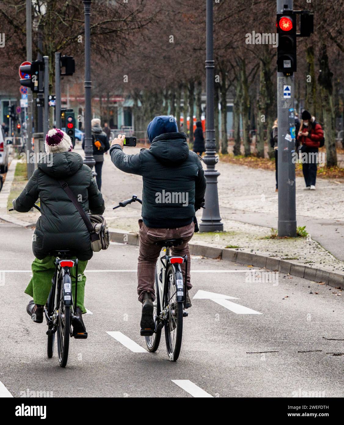 Cyclist Uses His Mobile Phone In Road Traffic, Berlin, Germany Stock Photo