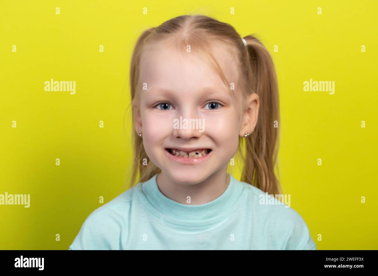 Portrait of a smiling seven-year-old girl with growing molars and