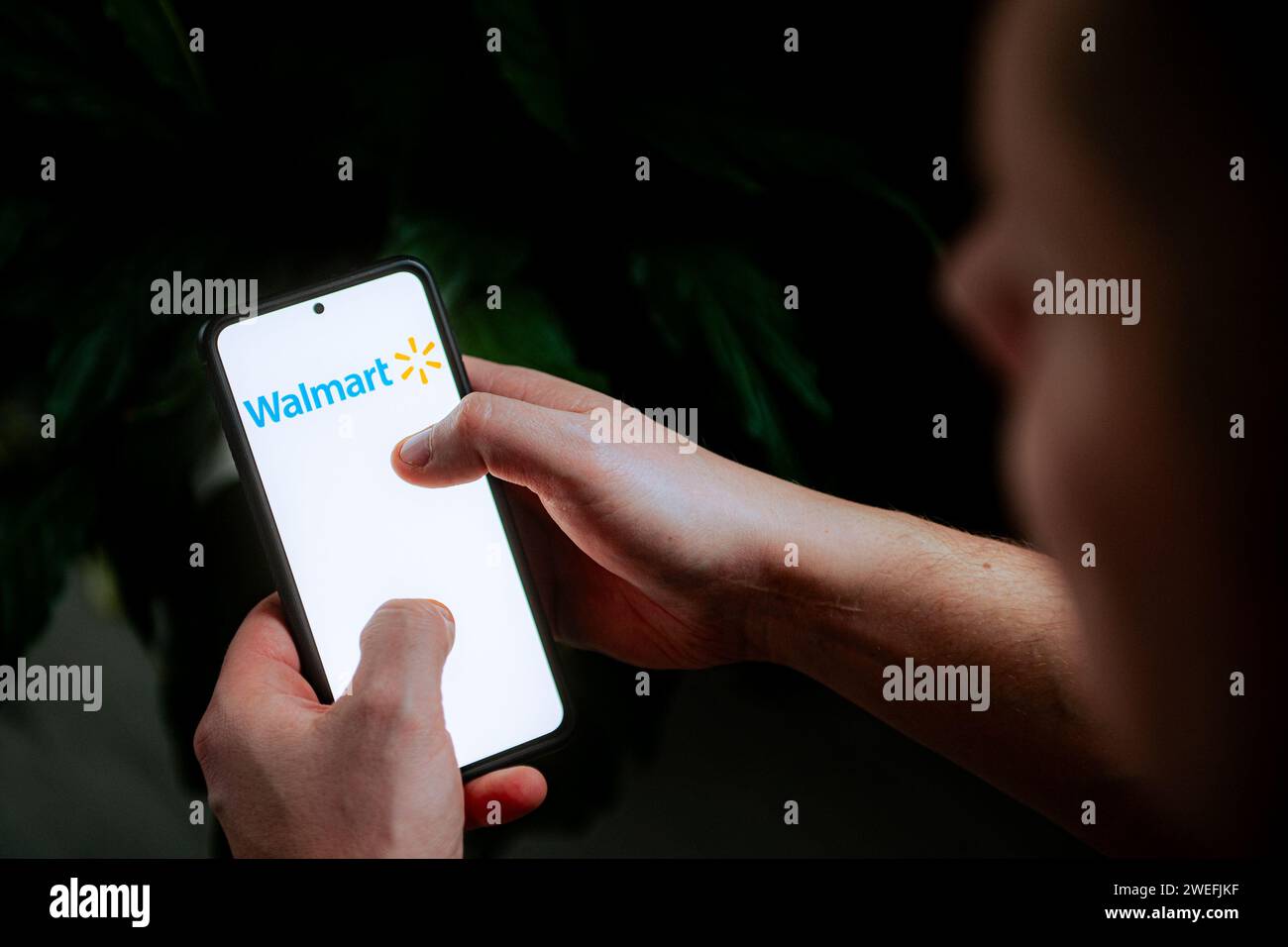 In this photo illustration a Walmart logo seen displayed on a ...