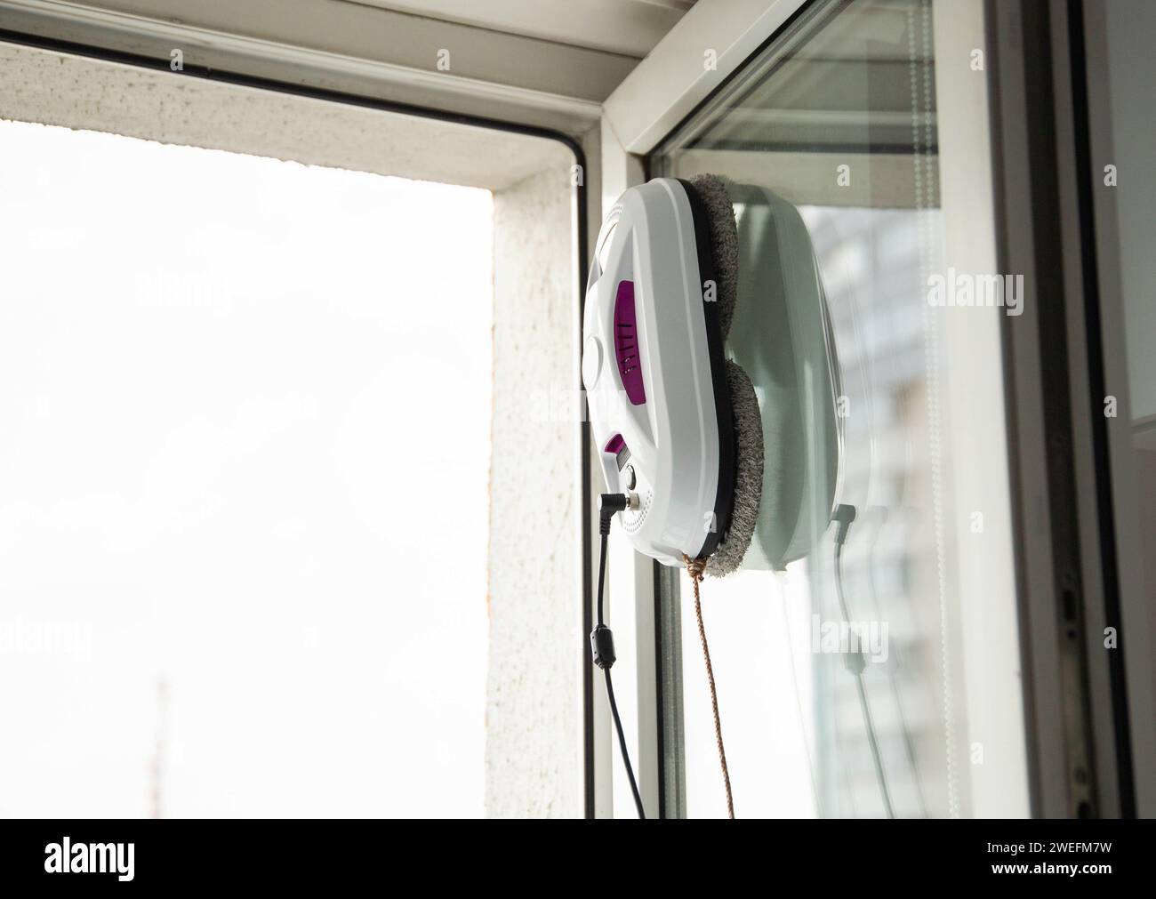 A modern device, a vacuum robot window cleaner, cleans glass from dirt