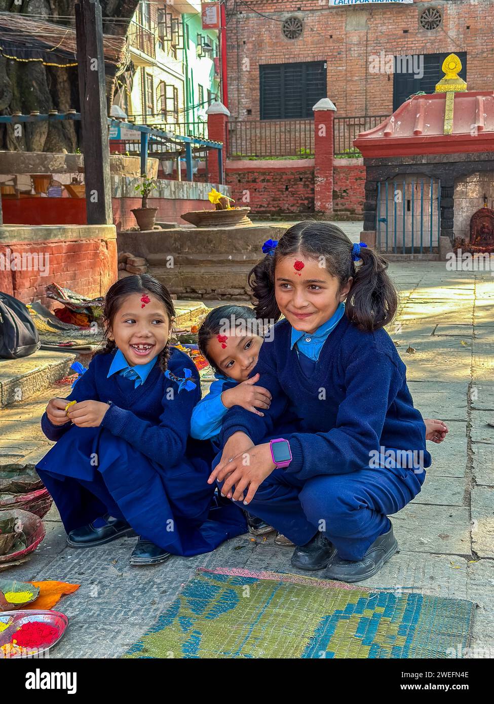 Trree nepaleses girls in school costume, closed to Kumbheshwor Temple. Patan, Bagmati, Nepal Stock Photo