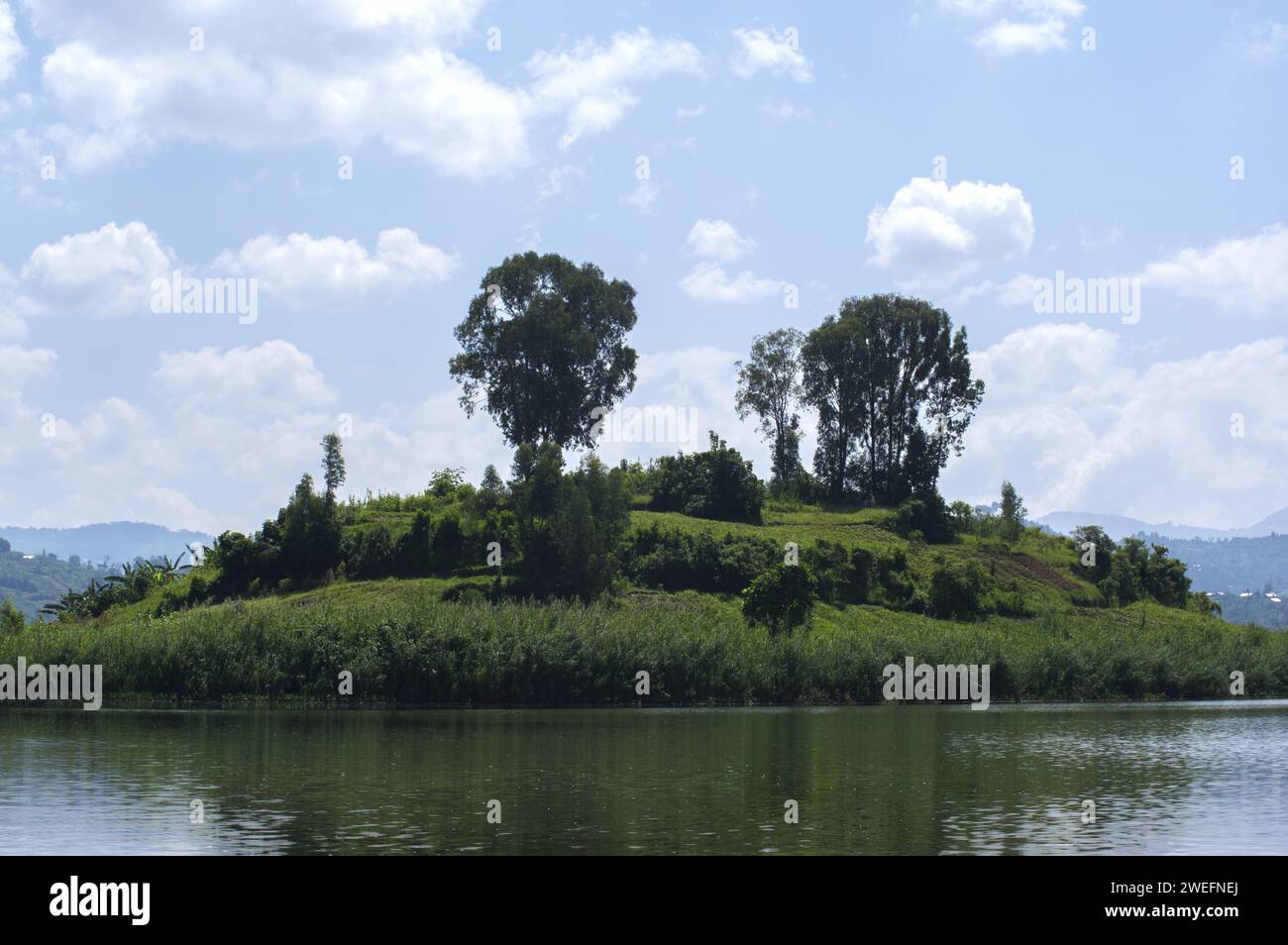 Boat trip in Musanze, Ruhengeri, Rwanda with vivid green islands near Volcanoes National Park in Rwanda Stock Photo