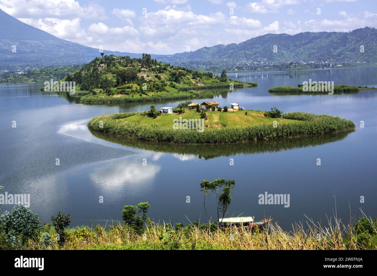 Boat trip in Musanze, Ruhengeri, Rwanda with vivid green islands near Volcanoes National Park in Rwanda Stock Photo