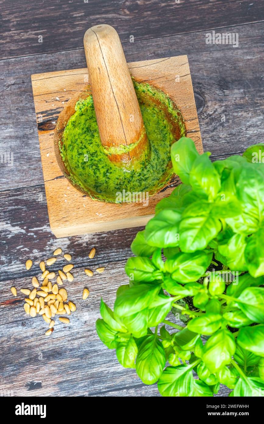 Homemade pesto in wooden pestle and mortar Stock Photo Alamy