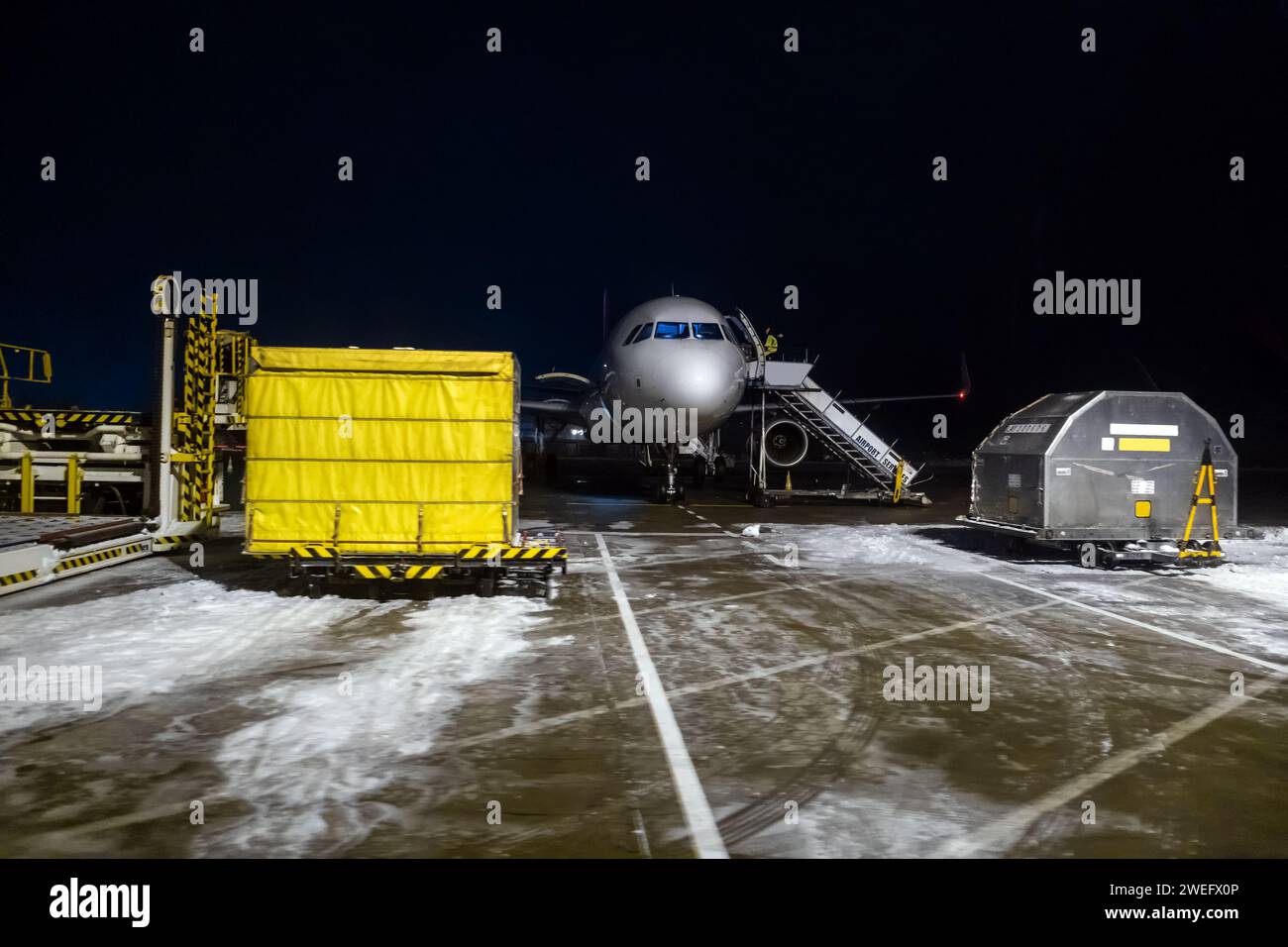 Area services on the airstrip at night at Otopeni Airport, Bucharest, Romania Stock Photo