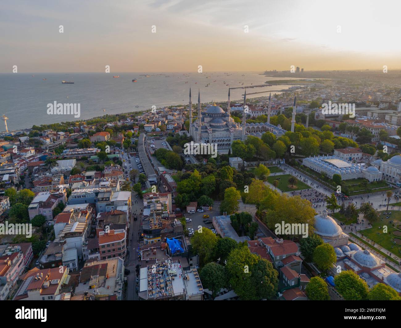 Blue Mosque Sultan Ahmet Camii aerial view at sunset with Sea of Marmara in Sultanahmet in historic city of Istanbul, Turkey. Historic Areas of Istanb Stock Photo