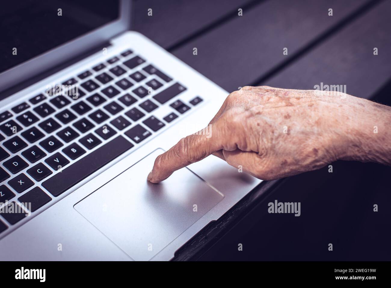 old persons finger on computer keyboard Stock Photo