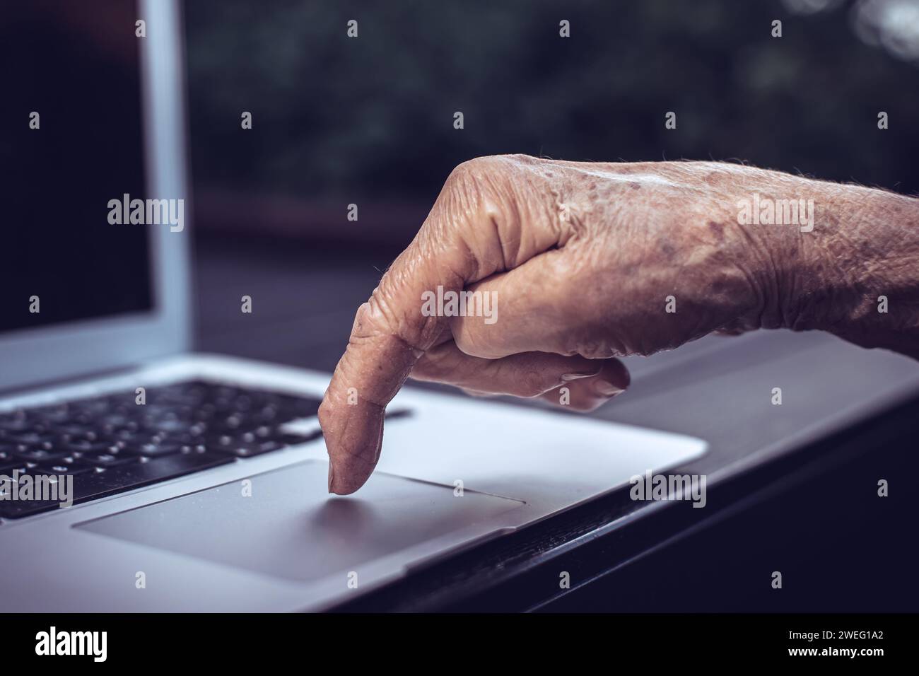 old persons finger on computer keyboard Stock Photo