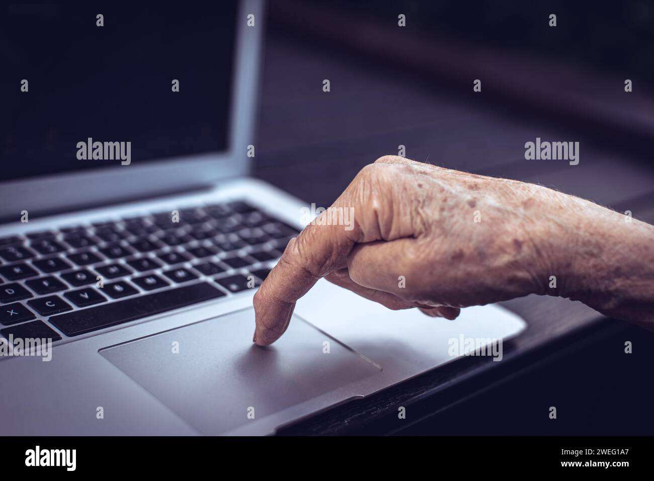 old persons finger on laptop keyboard Stock Photo