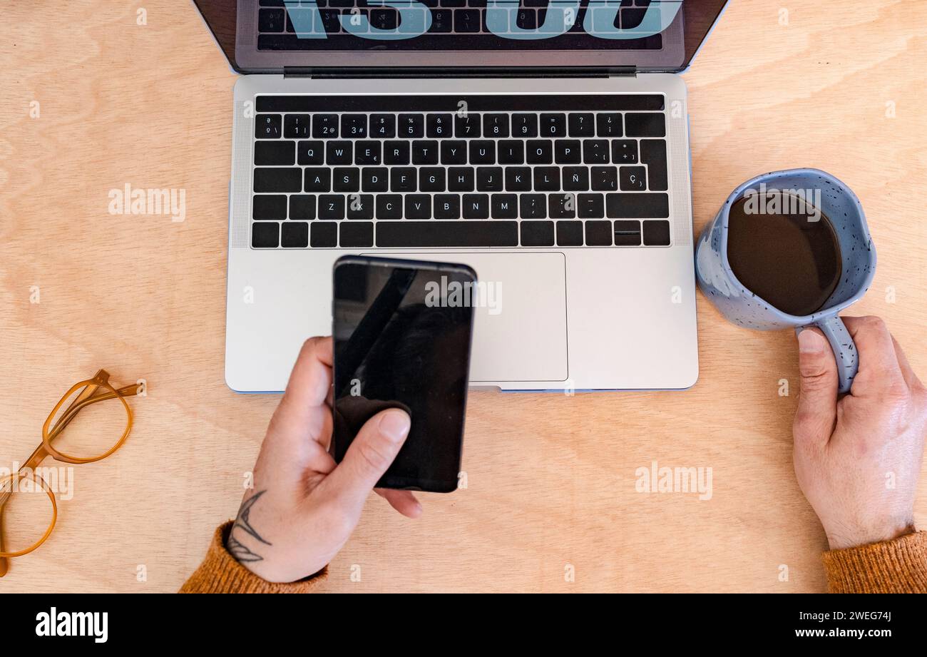 laptop and smartphone on wooden desk with coffee Stock Photo