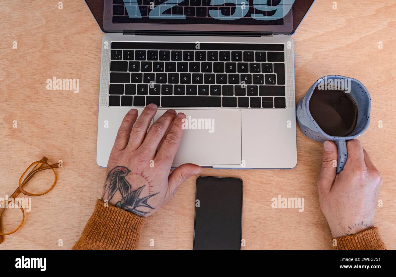 laptop and smartphone on wooden desk with coffee Stock Photo