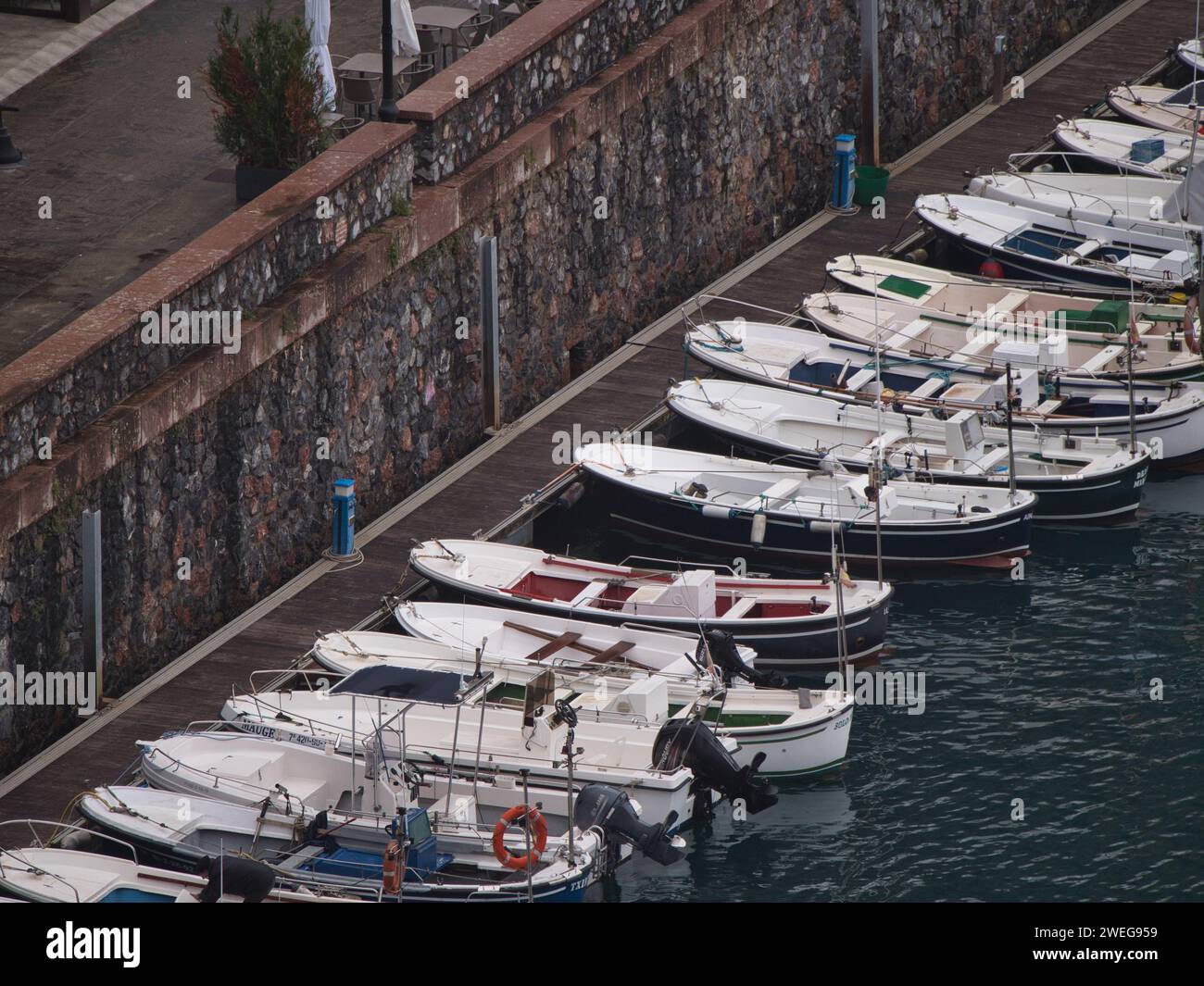 Small boats lined up at the harbor dock Stock Photo - Alamy
