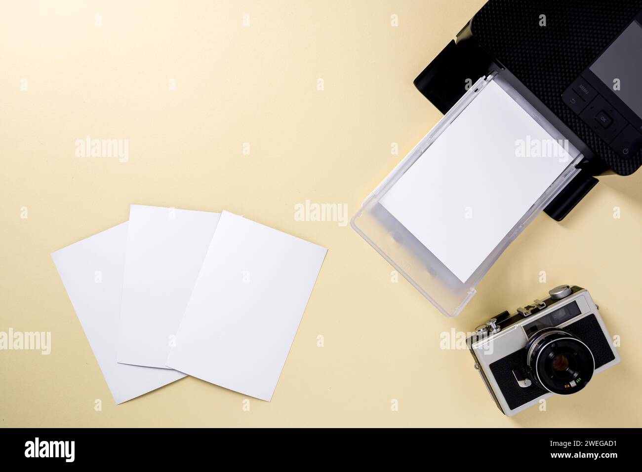 Top view of retro camera, blank photo papers and mobile photo printer Stock Photo