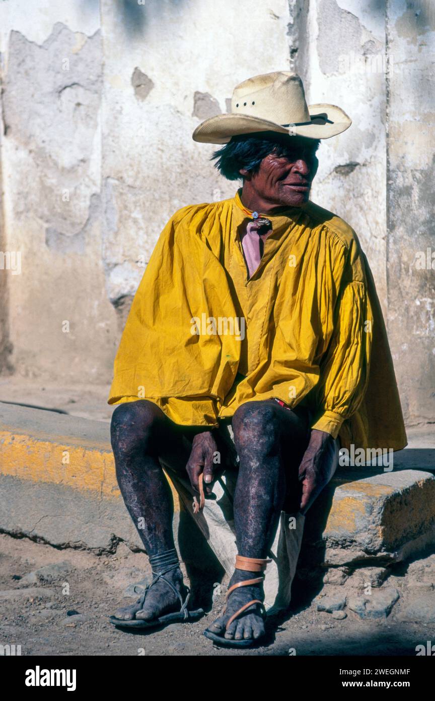 Tarahumara man, fixing his shoes in Batopilas, Copper Canyon region, Mexico Stock Photo