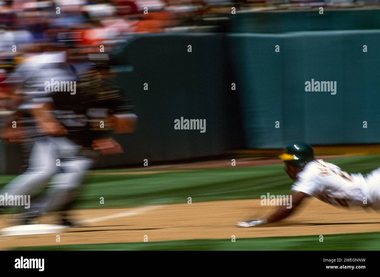 Ricky Henderson steals third base for the A's at the Oakland Coliseum, Oakland, California Stock Photo
