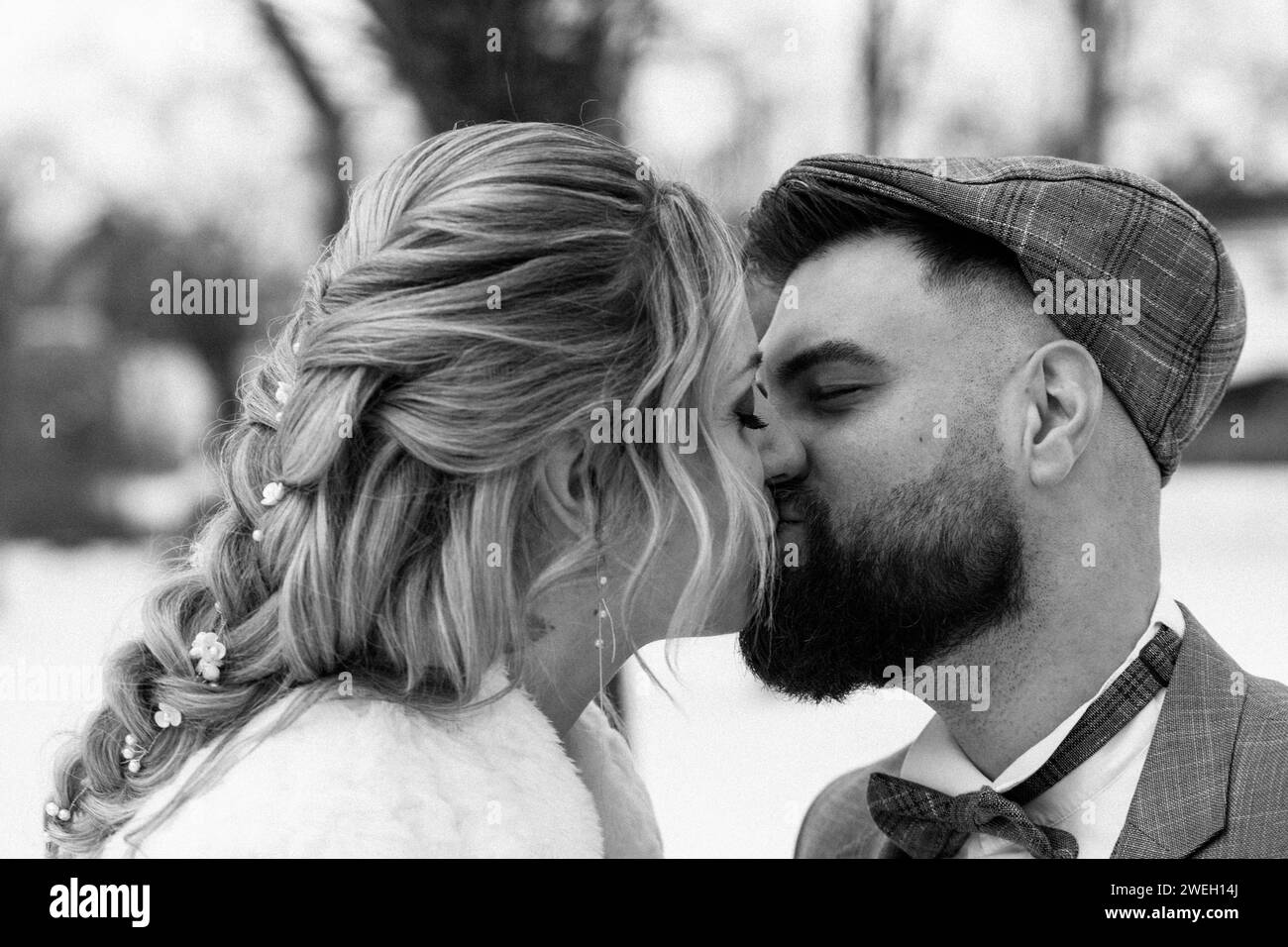 Bavaria, Germany - January 19, 2024: Young man and young woman kissing at their wedding *** Junger Mann und junge Frau küssen sich bei Ihrer Hochzeit Stock Photo