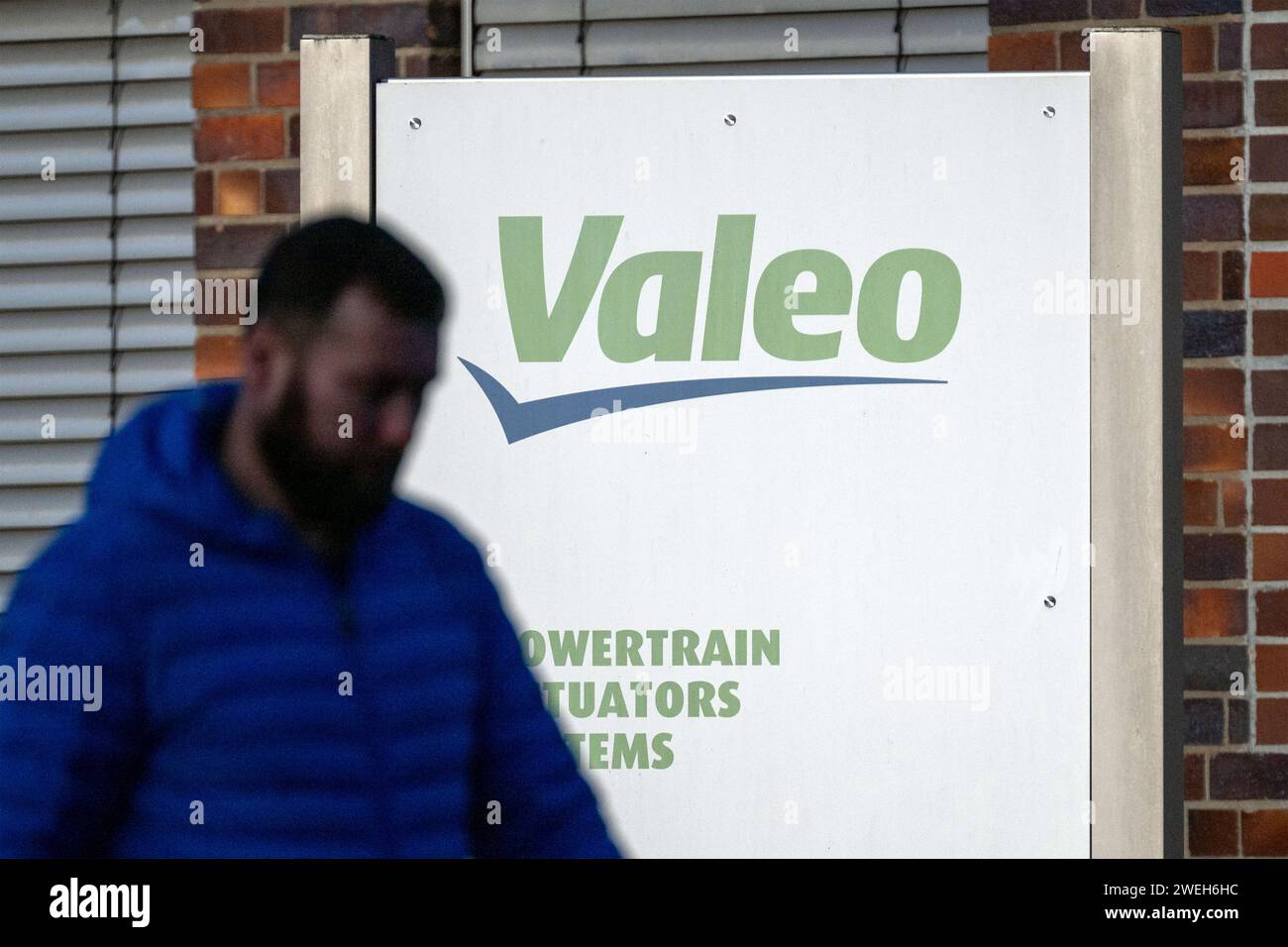 Ebern, Germany. 25th Jan, 2024. A man walks past with his head bowed in