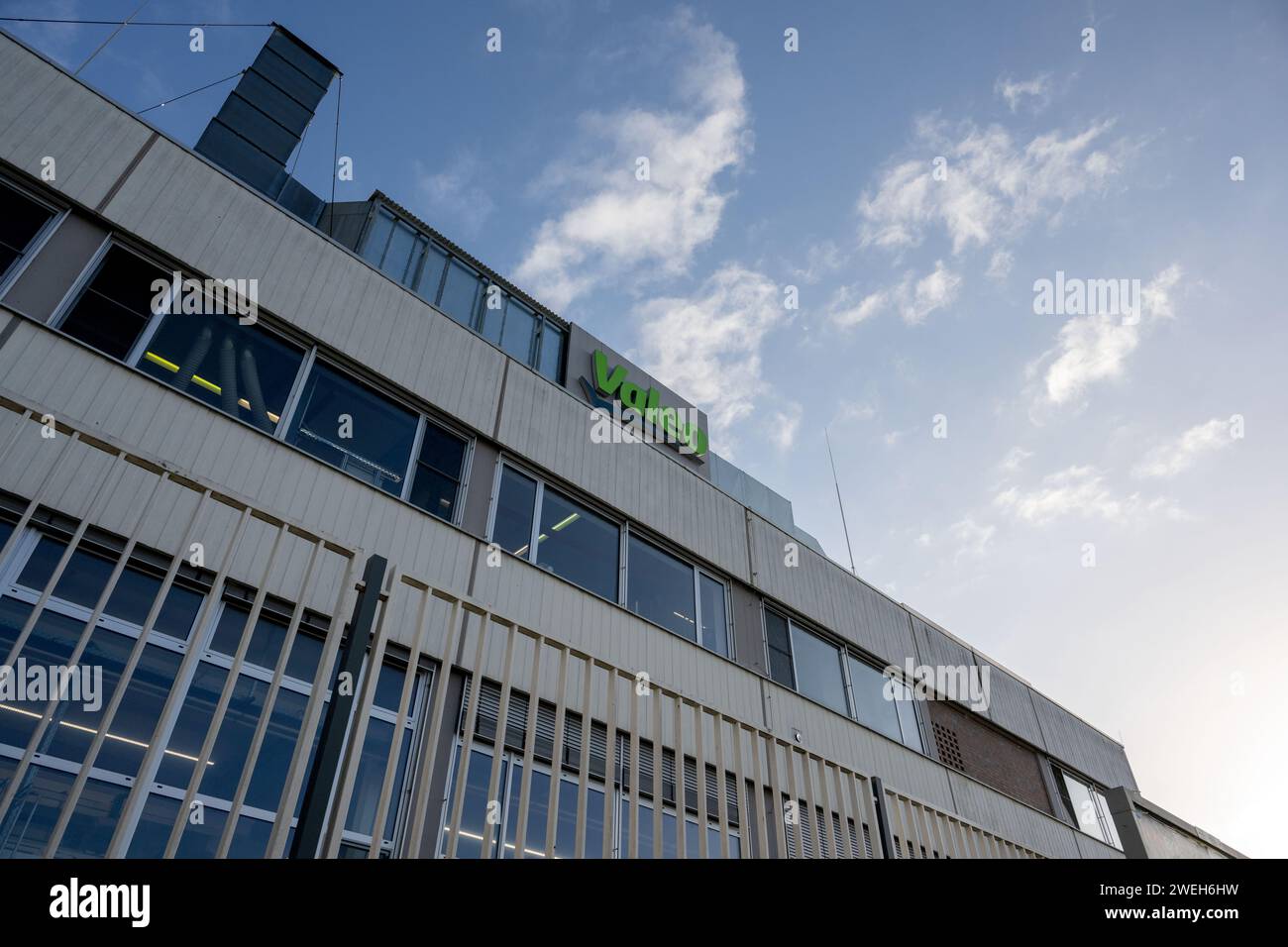Ebern, Germany. 25th Jan, 2024. Clouds in the sky above the building of automotive supplier Valeo. Credit: Pia Bayer/dpa/Alamy Live News Stock Photo
