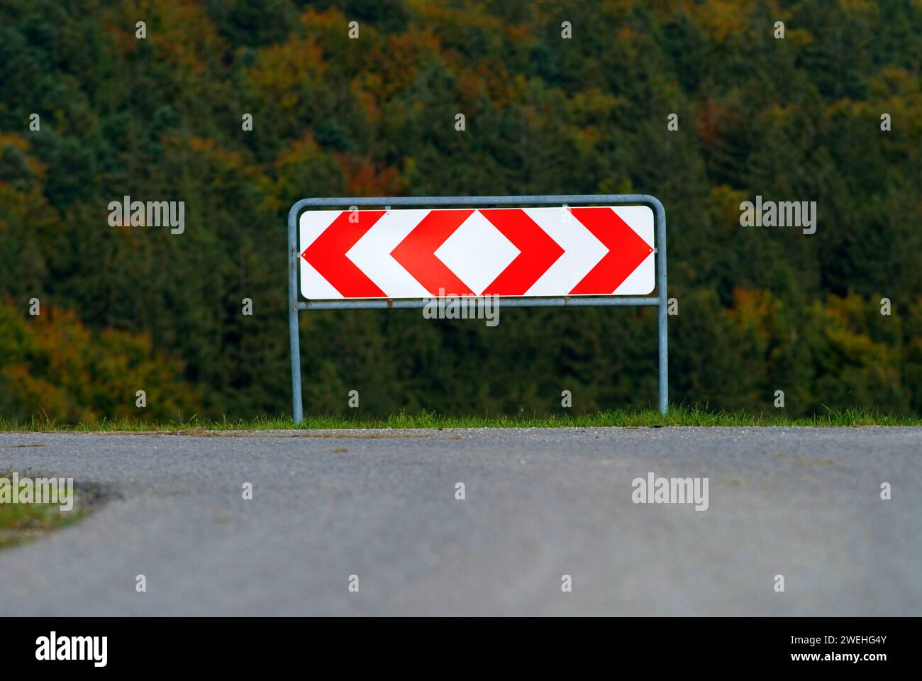Fork in the road in Germany, a sign shows the possible directions right and left, symbolising a Scheideweg, making a decision Stock Photo