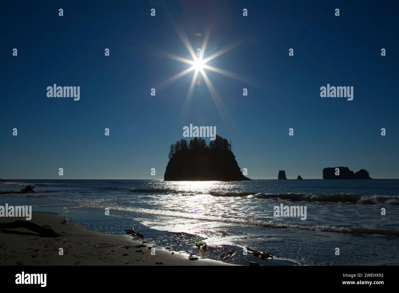 Seastack silhouette on Second Beach with sunburst, Olympic National Park, Washington Stock Photo